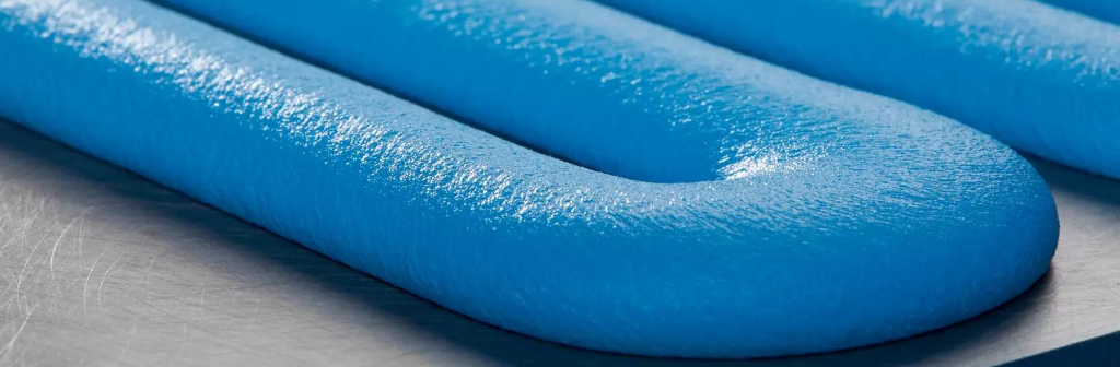 A dispensed thermal interface material bead, close up. This is what a filled, high-viscosity TIM looks like when the shot weight and bead profile are actually under control.